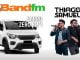 Anúncio promocional da Band FM com a dupla Thiago & Samuel oferecendo a chance de ganhar um carro 0km. Para participar, envie a mensagem "QUERO PARTICIPAR DE GRAÇA!".