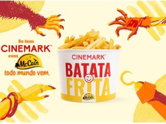 Um balde de batata frita da Cinemark com a marca McCain, rodeado por mãos que tentam alcançá-lo. O fundo amarelo destaca o slogan "Se tem Cinemark com McCain, todo mundo vem".