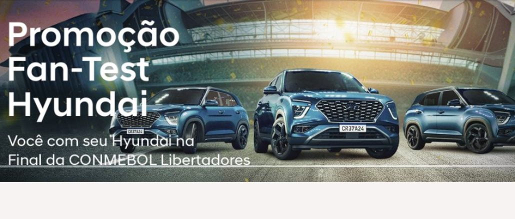 Promoção Fan-Test Hyundai Você na Conmebol Libertadores Imagem promocional da Hyundai com um carro Creta azul em destaque e a chamada "Promoção Fan-Test Hyundai". O texto descreve como participar da promoção, que inclui fazer um test drive e se cadastrar no site, para concorrer a prêmios como um vale-brinde, carros Hyundai 0km e uma viagem para a final da Libertadores.