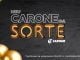 Banner promocional da campanha "Meu Carone da Sorte" do supermercado Carone. À esquerda, o título "MEU CARONE DA SORTE" em letras grandes e chamativas. Abaixo, informações sobre a promoção: a cada R$50 em compras, o cliente pode cadastrar seu cupom fiscal no site ou app do Carone e concorrer a um Volvo EX30 Core E40 e uma moto BMW G310R. O passo a passo para participar inclui fazer cadastro no app Clube Carone e informar o CPF no ponto de venda (PDV). É necessário informar o CPF a cada nova compra para que os cupons sejam cadastrados automaticamente. O cliente pode acompanhar tudo pelo aplicativo ou pelo portal do consumidor. À direita, uma imagem ilustrativa de um carro Volvo EX30 Core E40 branco e uma moto BMW G310R, com um fundo estilizado e elementos dourados decorativos.