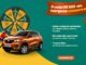 Anúncio de promoção do Aniversário Premiado Carajás apresentando uma roleta de prêmios, um carro laranja e uma moto vermelha. O fundo combina tons de verde escuro e amarelo, com uma faixa laranja no topo indicando que a cada R$500 em compras o cliente concorre a diversos prêmios.