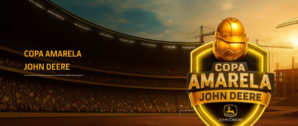 Banner promocional da Copa Amarela John Deere exibindo um grande escudo dourado com uma bola de futebol usando capacete de obra, posicionado à frente de um estádio lotado ao pôr do sol com guindastes de construção ao fundo.
