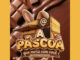 Arte promocional da campanha Páscoa que mora com você Armazzem, apresentando uma casa feita de chocolate e biscoitos decorada com orelhas de coelho sobre um fundo de chocolate derretido.