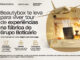 Anúncio publicitário da Beautybox sobre uma promoção que oferece uma viagem com tudo pago para conhecer a fábrica do Grupo Boticário. A imagem destaca um avião dourado sobrevoando uma mala aberta com perfumes, passaporte e frascos de laboratório.