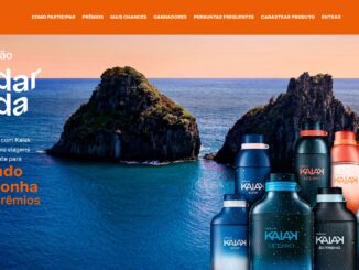 Banner promocional da Natura Kaiak intitulado Vai dar onda. A imagem apresenta frascos de perfumes da linha Kaiak em primeiro plano, posicionados à direita. Ao fundo, destaca-se uma paisagem paradisíaca de Fernando de Noronha com formações rochosas no mar e um céu em tons de pôr do sol. O texto à esquerda detalha a promoção.