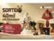 Banner promocional do programa Zé Compensa anunciando o sorteio de R$40.000 em chocolates. A imagem exibe diversos produtos da Kopenhagen, como ovos de Páscoa e caixas de bombons, cercados por ondas de chocolate derretido sobre um fundo bege claro. Um selo vermelho à esquerda destaca prêmios de R$500 em vales-presente.