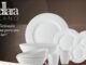 Logotipo da marca Livellara Milano e frase promocional ao lado de um conjunto de louças brancas composto por pratos de diversos tamanhos, tigelas empilhadas e canecas com detalhes em relevo circular.