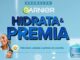 Banner publicitário da Garnier com o título Hidrata e Premia. A imagem apresenta um fundo azul claro com fotos de pessoas cuidando da pele e um pote de creme hidratante facial.