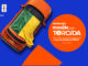 Banner digital com fundo azul exibindo um carro laranja com a bandeira do Brasil sobre o teto ao lado de um círculo laranja com informações sobre a promoção Movida pela Torcida para a Copa do Mundo da FIFA 26.