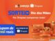 Banner promocional do sorteio de Dia das Mães realizado pelo Zé Compensa em parceria com a Shopee. A imagem apresenta um fundo alaranjado com elementos circulares. Do lado direito, diversos itens de presente como uma bolsa, joias e perfume estão dispostos sobre pedestais dourados. No centro, destaca-se um anúncio de cupom no valor de R$2.000,00 para compras.