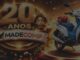 Promoção de aniversário de 20 anos da Madecomp, loja de Rondonópolis, Mato Grosso, com moto Honda branca e azul com laço vermelho como prêmio.