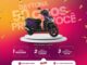 Peça publicitária da promoção Daytona 50 Anos Premia Você, com uma moto Honda Elite 125 2027 0km exposta sobre um pedestal branco, em fundo degradê de laranja a rosa, com confetes dourados.