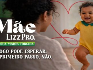 Bebê sorridente de cabelos cacheados e roupa amarela dando os primeiros passos em direção à mãe. A imagem contém o texto publicitário da marca Lizz Pro ressaltando que o primeiro passo é prioridade.
