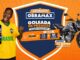 Banner da promoção Aniversário Obramax Goleada de Prêmios, com torcedor brasileiro vestindo camisa amarela da seleção comemorando, celular exibindo o jogo Chute ao Gol, escudo azul com os dizeres Goleada de Prêmios Pra Quem É Craque na Obra, faixa explicando que a cada R$400,00 em compras o cliente ganha um chute ao gol e um número da sorte, e moto Honda CG 160 Fan ao lado da informação de sorteio de 25 motos.