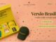 Banner promocional da Celina Locks Beauty com kit temático da Copa do Mundo contendo camisa da seleção brasileira número 9 de Ronaldo, boné amarelo com a frase "Brasil com S", vela aromática, embalagem de produto de beleza e caixa amarela, ao lado de um boné verde escuro com a frase "Versão Brasileira" bordada em dourado, sobre fundo salmão com estrelas douradas e verdes.