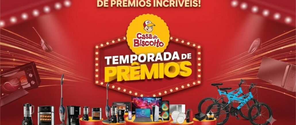 Banner da promoção Temporada de Prêmios Casa do Biscoito 2026, com diversos prêmios expostos sobre pedestais, incluindo eletrodomésticos, eletrônicos e bicicletas, sobre fundo vermelho.