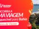 Banner vermelho da promoção de 40 anos da Viezzer Supermercados com sorteio de viagem para a Bahia, mostrando resort à beira-mar com coqueiros, confetes dourados e balão vermelho.