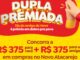 Banner promocional Dupla Premiada Novo Atacarejo com fundo amarelo e vermelho, mãos em gesto de agradecimento e valores de R$375 para você e R$375 para um amigo em compras no Novo Atacarejo