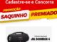 Banner vermelho e amarelo da Promoção Saquinho Premiado, com caixa de som JBL Boombox 4 preta ao centro, anunciando o Prêmio Nacional e a chamada Cadastre-se e Concorra.