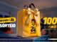 Sacola dourada do Zé Delivery com laço de fita dourada sobre uma mesa, ao lado do texto "Niver do Zé – Sorteio 100 mil em Certificado de Ouro".