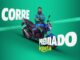 Entregador sorridente com jaqueta verde da Keeta, de braços cruzados ao lado de uma motocicleta azul, sobre fundo verde com o título Corre Premiado Keeta.