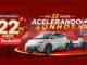 Banner da promoção de aniversário de 22 anos da RedeMiX na Bahia, com o slogan "Há 22 anos acelerando sonhos!", um carro elétrico BYD Dolphin Mini na cor bege, uma motocicleta branca e vermelha e o selo "Compre 1 produto parceiro e ganhe sorte extra".