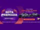 Banner roxo da promoção Rota Premiada Speedmax Pneus com dois SUVs cinza, uma motocicleta, botão Quero Participar e homem de cabelos grisalhos sorrindo à direita.