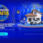 Banner da promoção Aniversário Cometa 2026 com fundo azul, uma casa, um carro SUV branco e várias motos sobre um palco iluminado, com a mensagem a cada R$150,00 em compras receba 1 número da sorte.