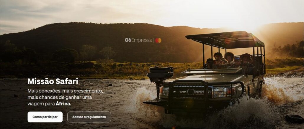 Expedição África C6 Bank Banner da campanha Missão Safari do C6 Empresas com Mastercard, mostrando um veículo de safári com passageiros atravessando um rio ao pôr do sol na África.