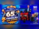 Arte da campanha 65 Anos do Super São Geraldo, com o selo "Tradição que premia" e balões, um homem de terno azul sobre uma moto elétrica vermelha, eletrodomésticos e a indicação de 90 dias de ofertas.