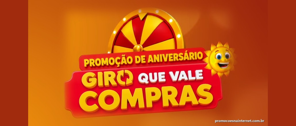 Logotipo da promoção de aniversário Giro que Vale Compras, da Rede Sol Supermercados, com roleta dourada e vermelha, faixa vermelha com o nome da campanha em amarelo e branco e o sol sorridente da marca, sobre fundo laranja.