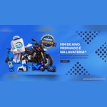 Mascote da Lavateria em forma de máquina de lavar com boné, ao lado de uma moto Honda CB300F, scooter elétrica, iPhone, PlayStation 5, Smart TV Samsung 4K e Echo Show 5, com o texto Fim de Ano Premiado é na Lavateria e o selo Prêmio Destaque
